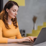 side-view-woman-working-laptop_23-2148781123